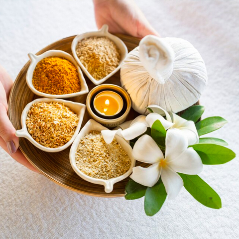 A serene spa setting featuring an array of spices and flowers, showcasing Flames Beauty Care & Bridal Studio's offerings.