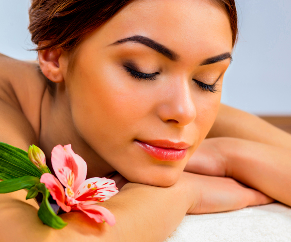 Flames Beauty Care & Bridal Studio, At Flames Beauty Studio, a woman with curly hair displays her stunning hairstyle, radiating beauty and confidence.