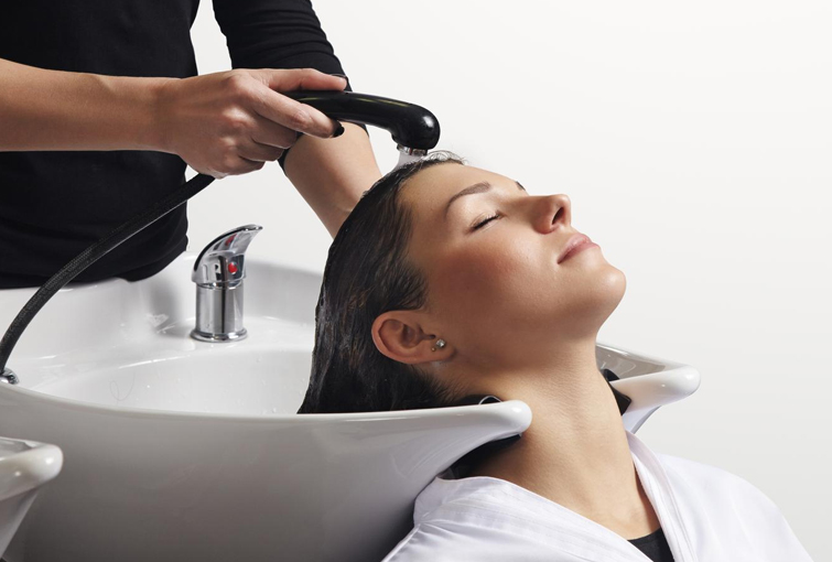 Flames Beauty Care & Bridal Studio, A woman enjoys a relaxing hair wash at Flames Beauty Studio, a serene hair spa experience.