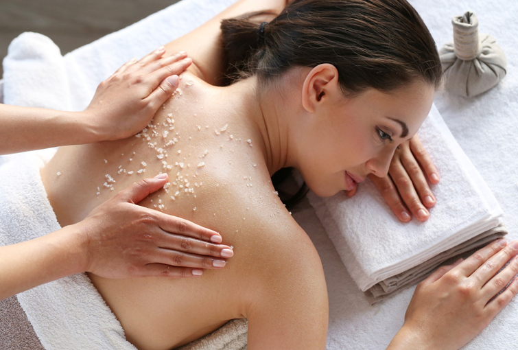 Flames Beauty Care & Bridal Studio, A woman at Flames Beauty Studio, experiencing a soothing massage with a towel on her back, highlighting beauty and relaxation services.